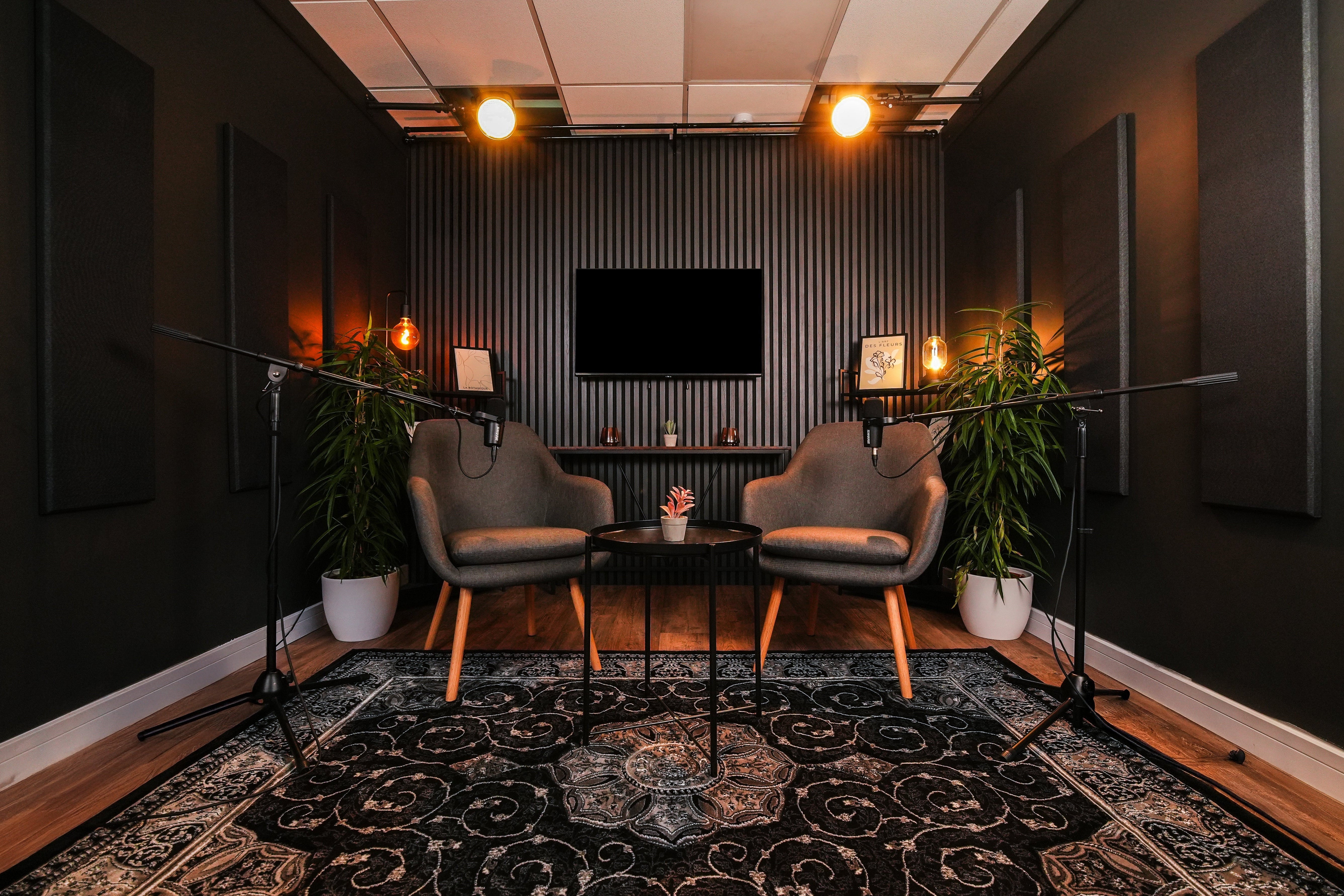 Aspect Ratio Sheffield soundproof podcast set with two grey armchairs and Shure microphones
